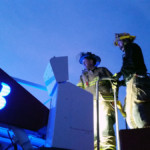 Firefighter Doug Blair manipulates the ladder to drop a cone on top of another cone