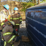 Firefighters set up a strut for stabilizing the vehicle