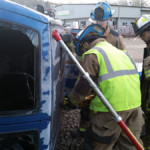 Joe Geiser cuts the van's roof using a reciprocating saw