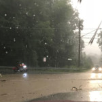 Water floods across Franklin Pike at the intersection with Liberty St