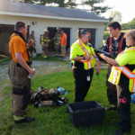 Firefighters Kyle Corey and Mike Rayburn are checked by Meadville Ambulance personnel