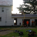 Lieutenants Ryan Porter and Mike Chornack stretch a 1 3/4" handline to the roof to finish overhaul.